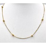 A 14K Yellow Gold Necklace with Ball Decoration. 40cm. 2g weight.