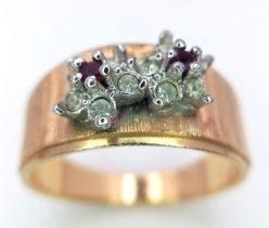 An 18K Yellow Gold Garnet and Diamond Ring. Two small garnets with diamond surrounds. Size N. 3.7g