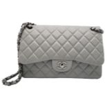 A Chanel Grey Caviar Jumbo Classic Double Flap Bag. Quilted leather exterior with silver and