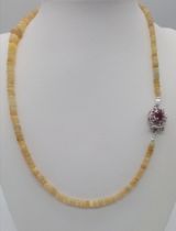 A 77ctw Rondelle Opal Necklace with a Ruby and 925 Silver Clasp. 47.5cm length, 14.53g total weight.