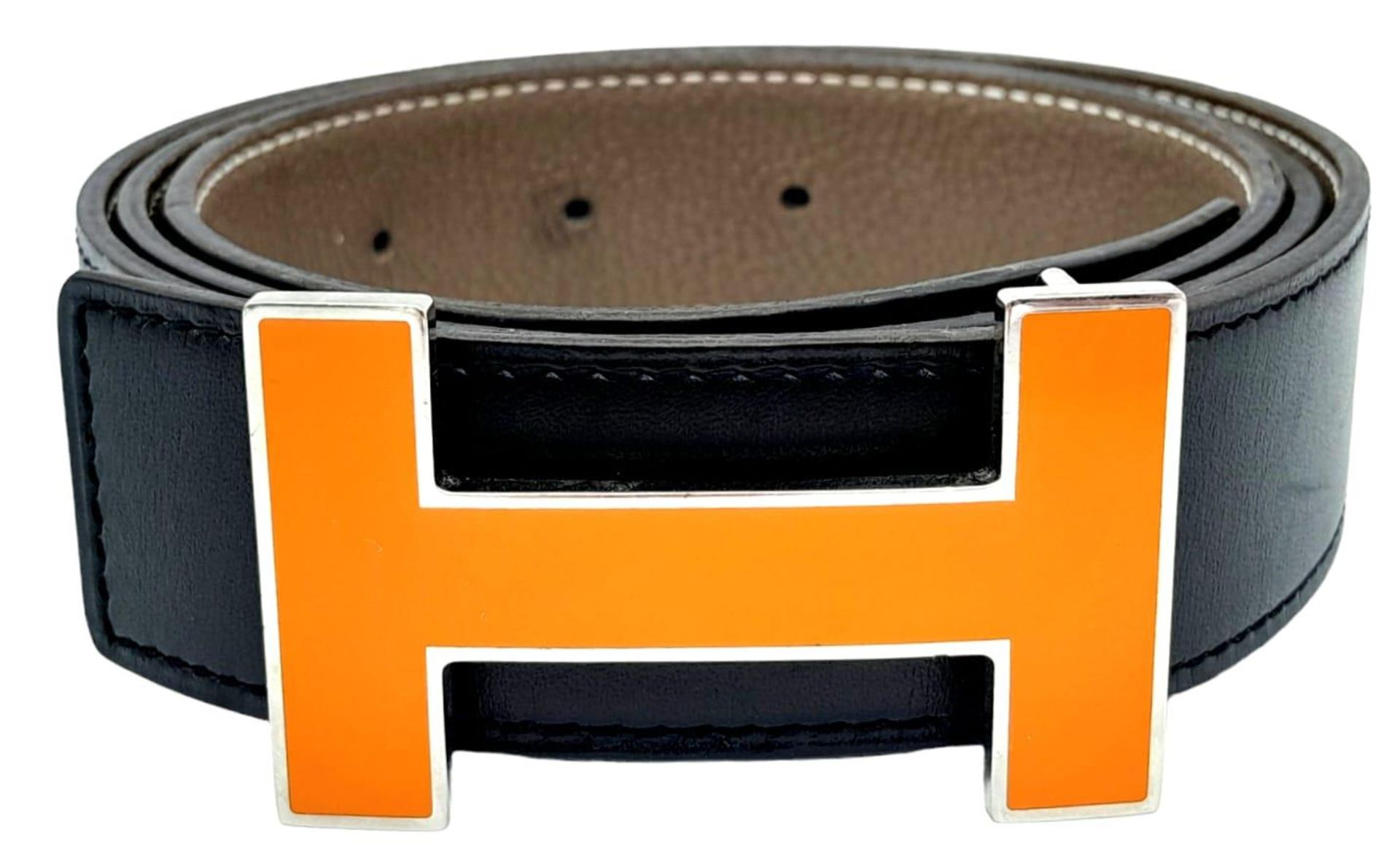 A Hermes Black Leather H Logo Constance Changeable Belt. Silvertone H Buckle with Orange Enamel.