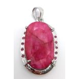 An Oval Shape Ruby Gemstone Pendant set in 925 Silver with Ruby Accents. 24.20g total weight.