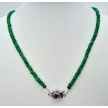 A 70ctw Emerald Necklace with a Ruby and 925 Silver Clasp. 46.5cm length, 17g total weight. Ref: