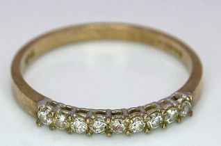 A 9K YELLOW GOLD 0.25CT DIAMOND BAND RING. TOTAL WEIGHT 1.2G. SIZE SIZE M 1/2