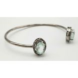 An Aquamarine and Diamond Cuff Bracelet. Aquamarine - 8 ctw. Diamonds - 0.50ctw. Set in sterling