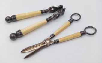 A PAIR OF VICTORIAN BONE HANDLED UTENSILS , NUT CRACKERS AND GRAPE SCISSORS (SCISSORS HAVE A CHIP IN