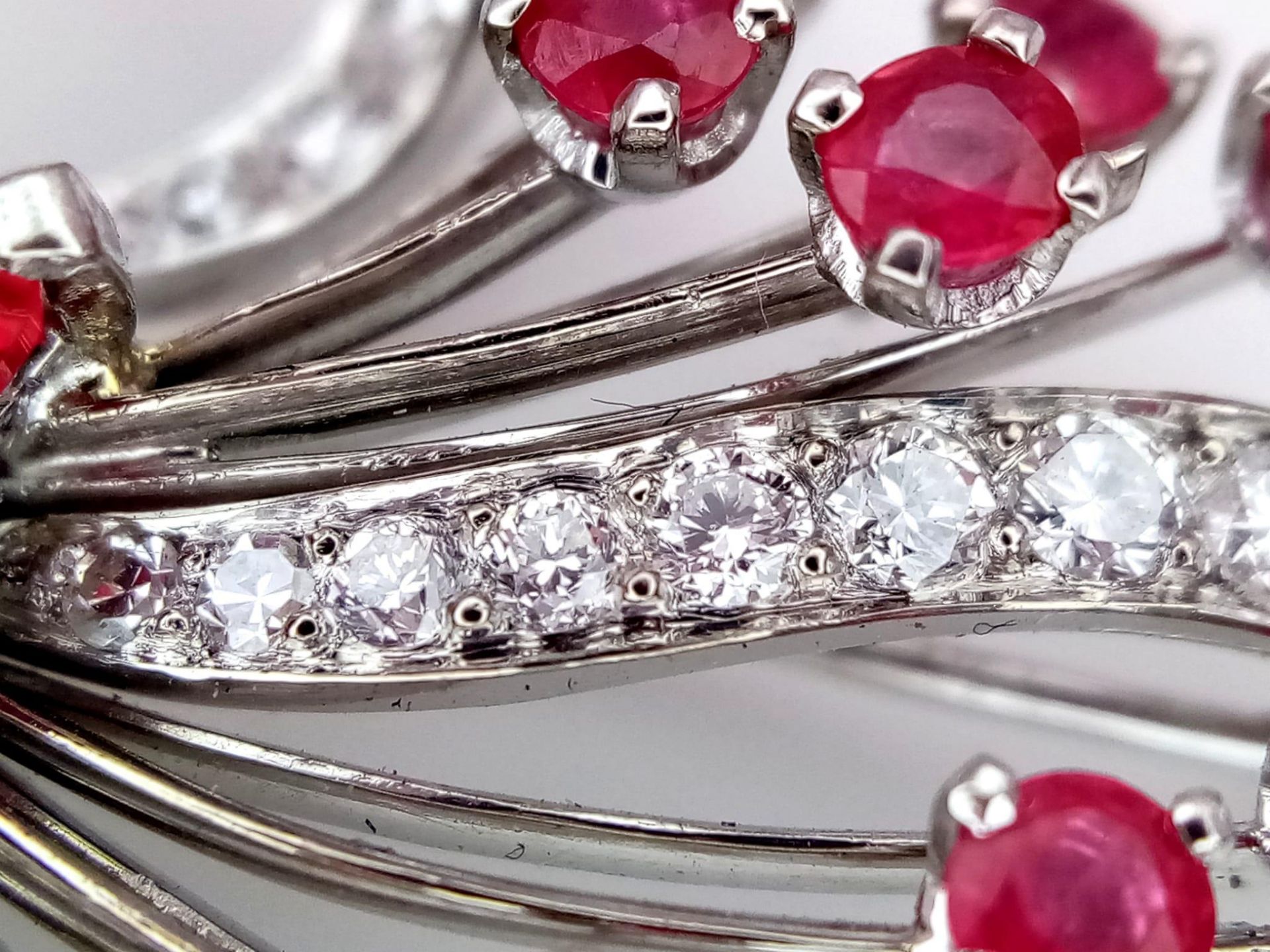 A STUNNING DIAMOND AND RUBY BROOCH SET IN PLATINUM , A MAJESTIC SPRAY OF RUBIES EMINATING FROM A - Image 5 of 7