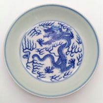 A GUANGXU ERA CHINESE DISH WITH PAINTING OF A 5 CLAWED DRAGON AND NUMBERED ON THE BOTTOM . 17cms
