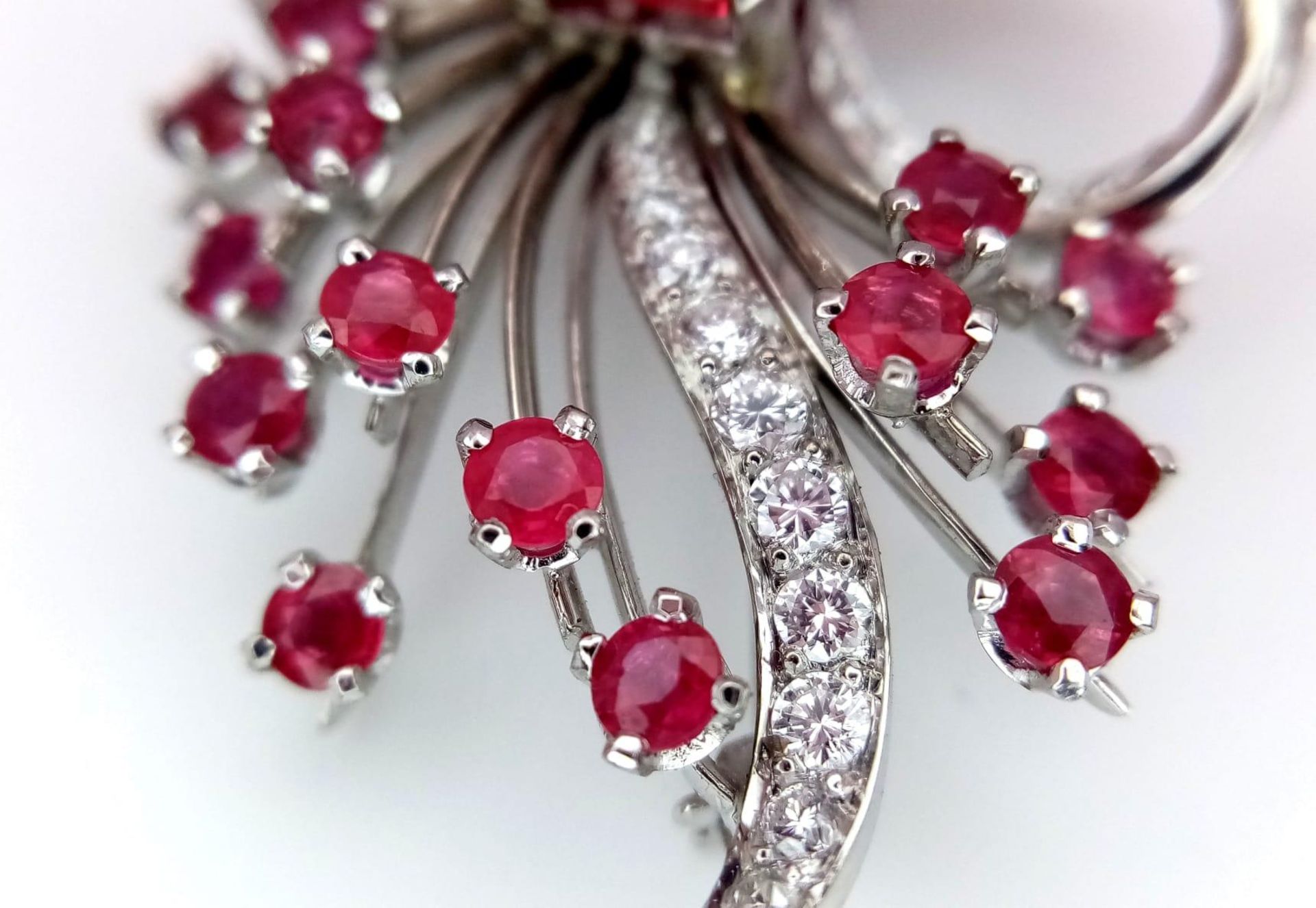 A STUNNING DIAMOND AND RUBY BROOCH SET IN PLATINUM , A MAJESTIC SPRAY OF RUBIES EMINATING FROM A - Image 6 of 7