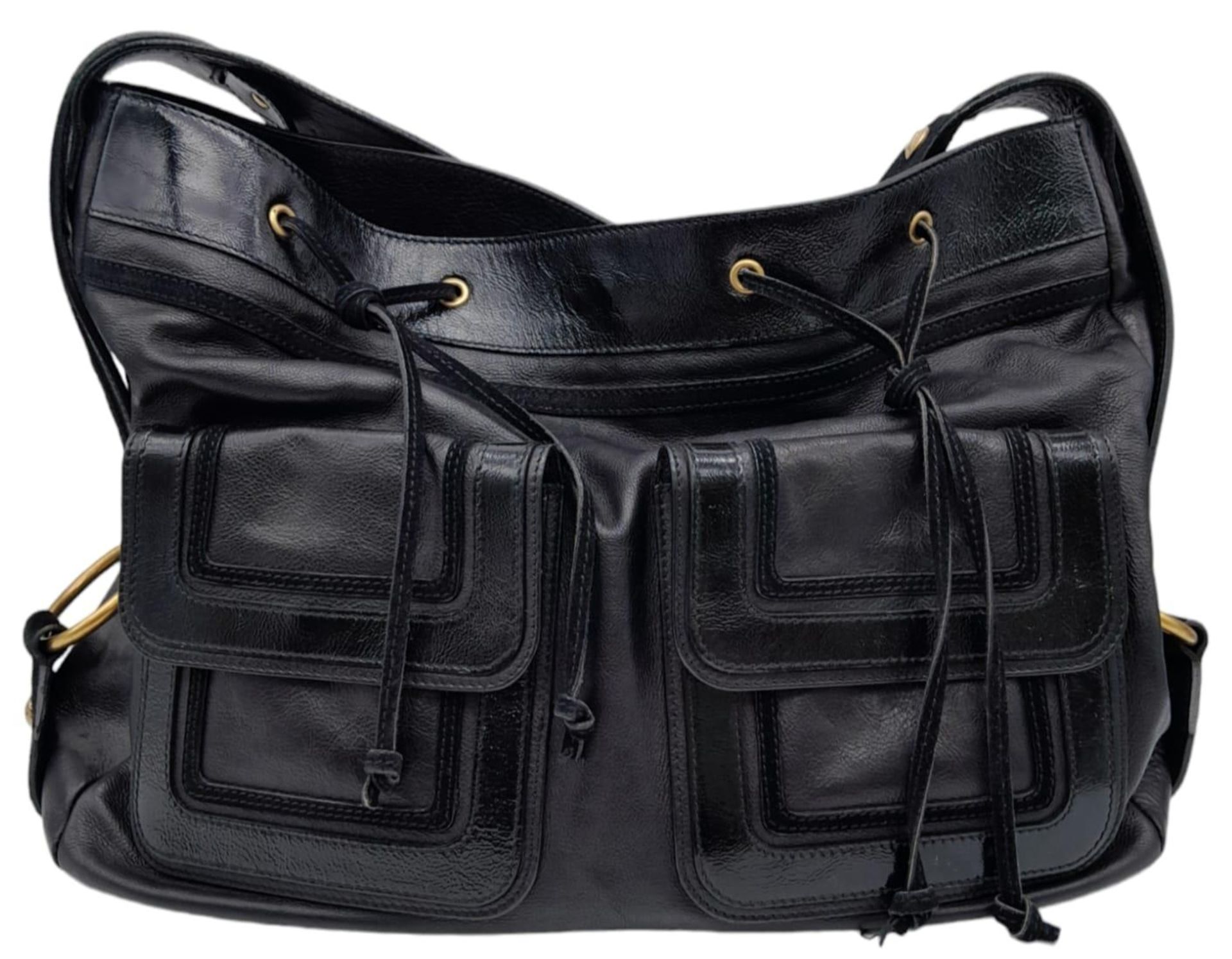 An Yves Saint Laurent Black Shoulder Bag. Leather exterior with patent leather details, gold-toned