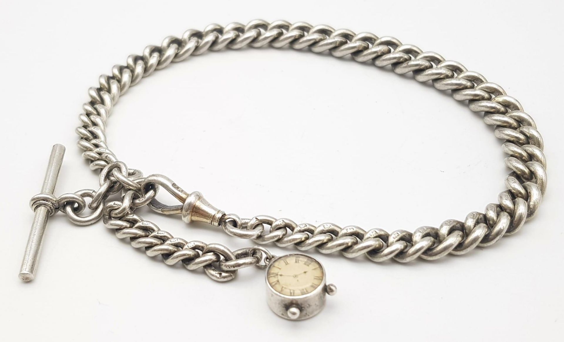 A VINTAGE STERLING SILVER ALBERT POCKET WATCH CHAIN WITH T BAR AND ALSO A CUTE MINI CLOCK CHARM