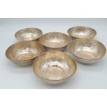 A SET OF 6 800 SILVER ISLAMIC CEREMONIAL DISHES . 12cms DIAMETER 498gms