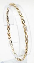 A Vintage 9K Yellow Gold and Diamond Spacer Crossover Link Bracelet. 18cm length. 2.37g total