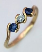 A 9K Yellow Gold Diamond and Sapphire Ring set in a Wave Pattern. Size K 1/2. 1.25g weight.