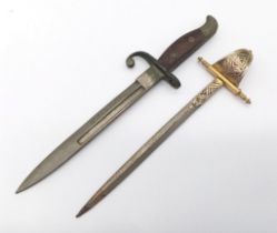 A miniature bayonet with Bruges on the blade and a miniature Toledo sword letter openers. Bayonet