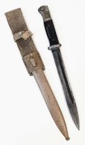 An Africa Corps Mauser K-98 Bayonet and Frog. Etched with the D.A.K logo on the pommel. Privately