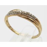 A 9K Yellow Gold Diamond Crossover Ring. Size M. 1.27g weight.