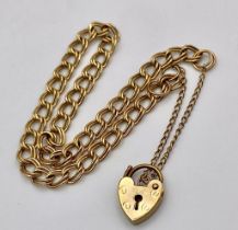 A 9K Yellow Gold Curb Link Bracelet with Heart Clasp. 4.83g weight. 18cm.