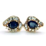 A PAIR OF 14K GOLD DIAMOND AND SAPPHIRE STUD EARRINGS WITH .50ct DIAMONDS AND 1.5ct OVAL SAPPHIRES .