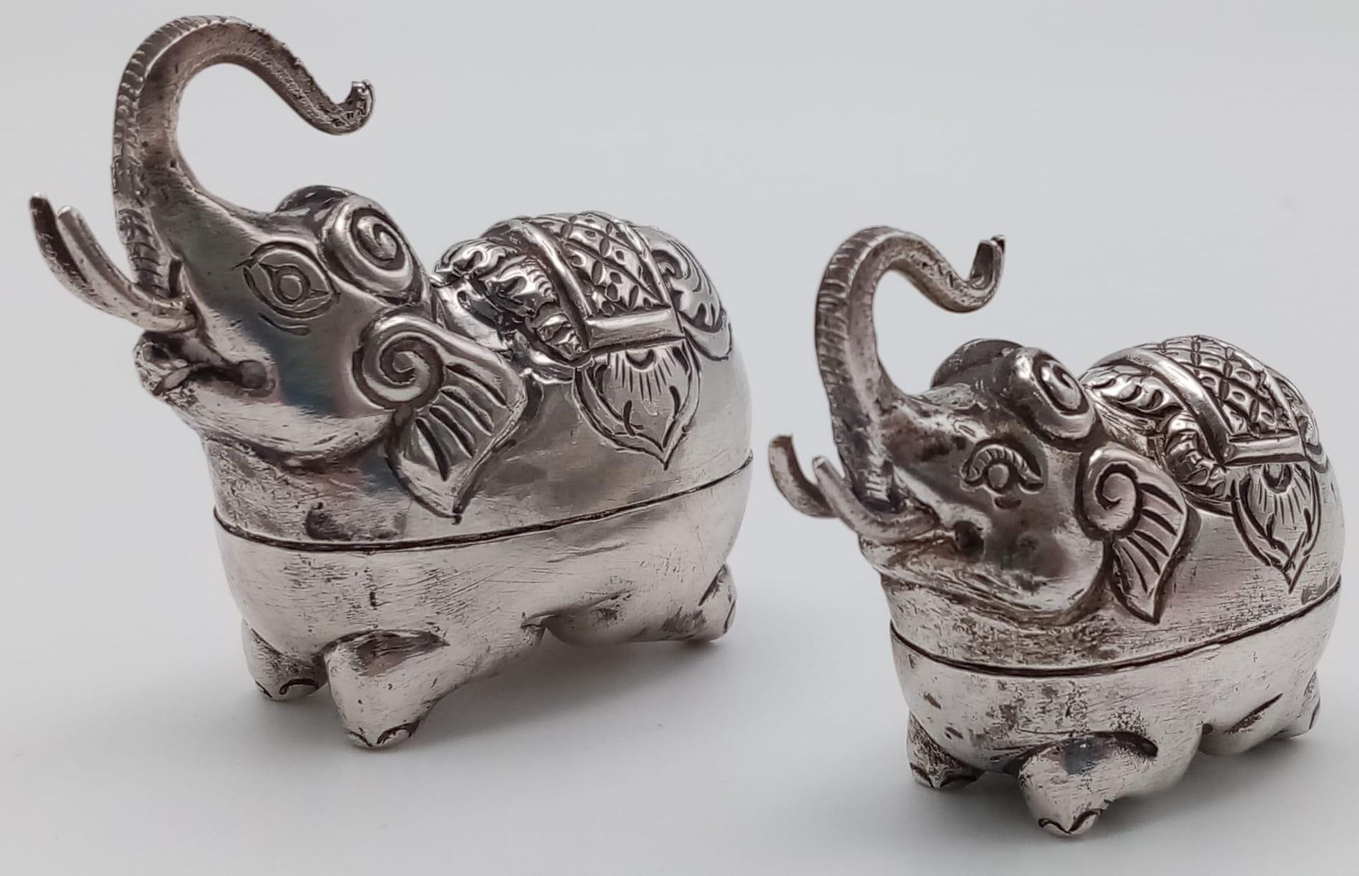 A pair of antique Cambodian silver elephant betel nut boxes. Made in the traditional Khmer silver