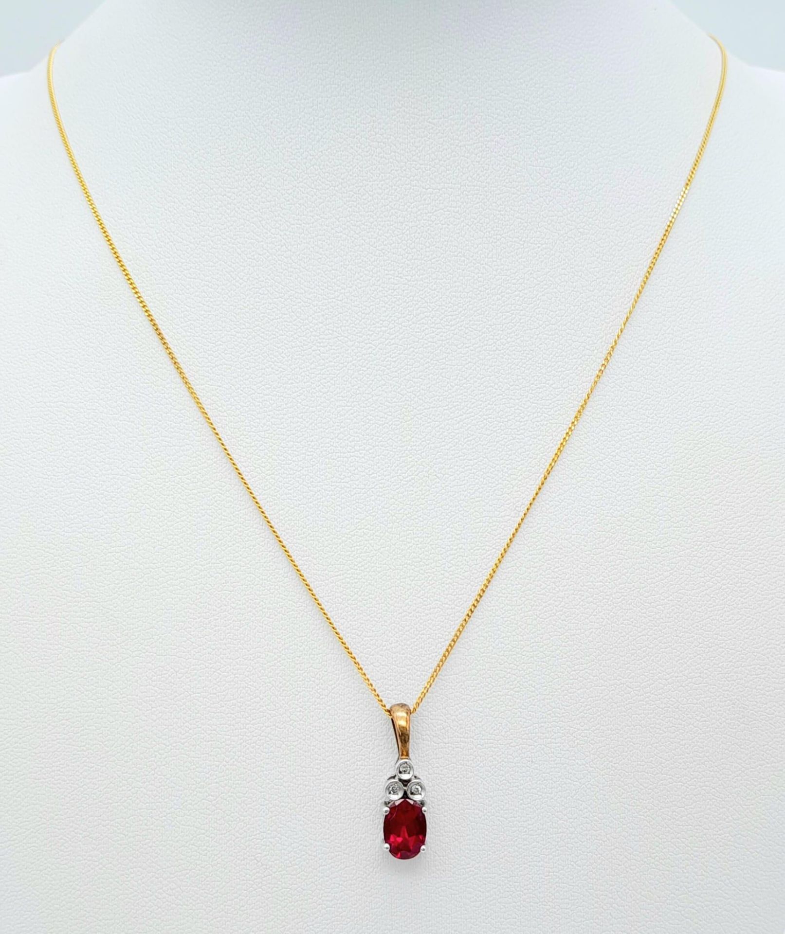 A 9K YELLOW GOLD DIAMOND & RED STONE PENDANT BELIEVED TO BE RUBY & 9K GOLD CHAIN 2.8G , 46cm length.