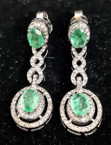 A Pair of Emerald and Diamond Drop Earrings on 925 Silver. Approximately 5ctw emeralds, 2.5ctw