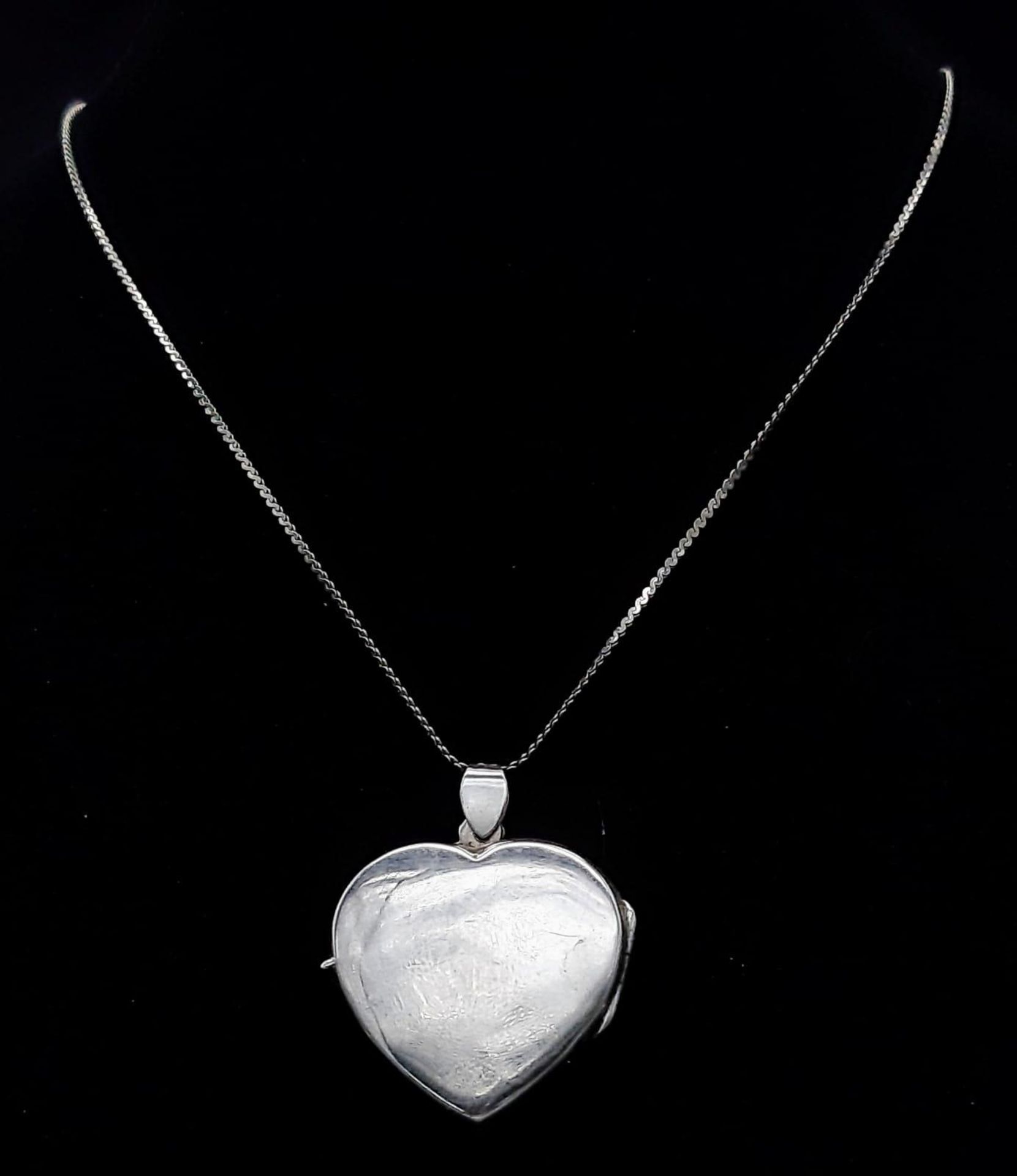 A vintage sterling silver heart locket pendant on 24K gold plated chain. Total weight 10G. Total