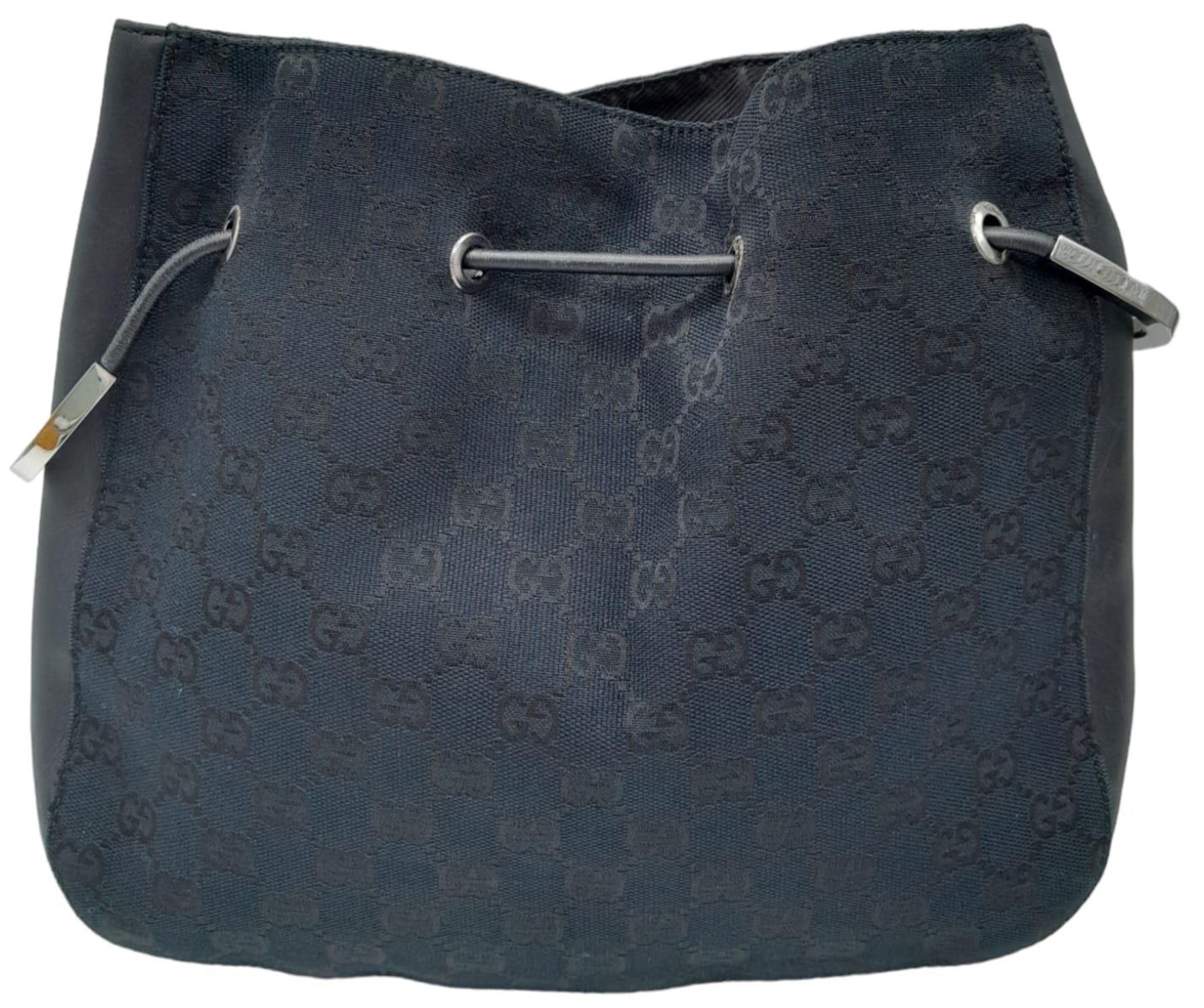 A Gucci Black Monogram Drawstring Shoulder Bag. Canvas exterior with silver-toned hardware, - Bild 3 aus 8