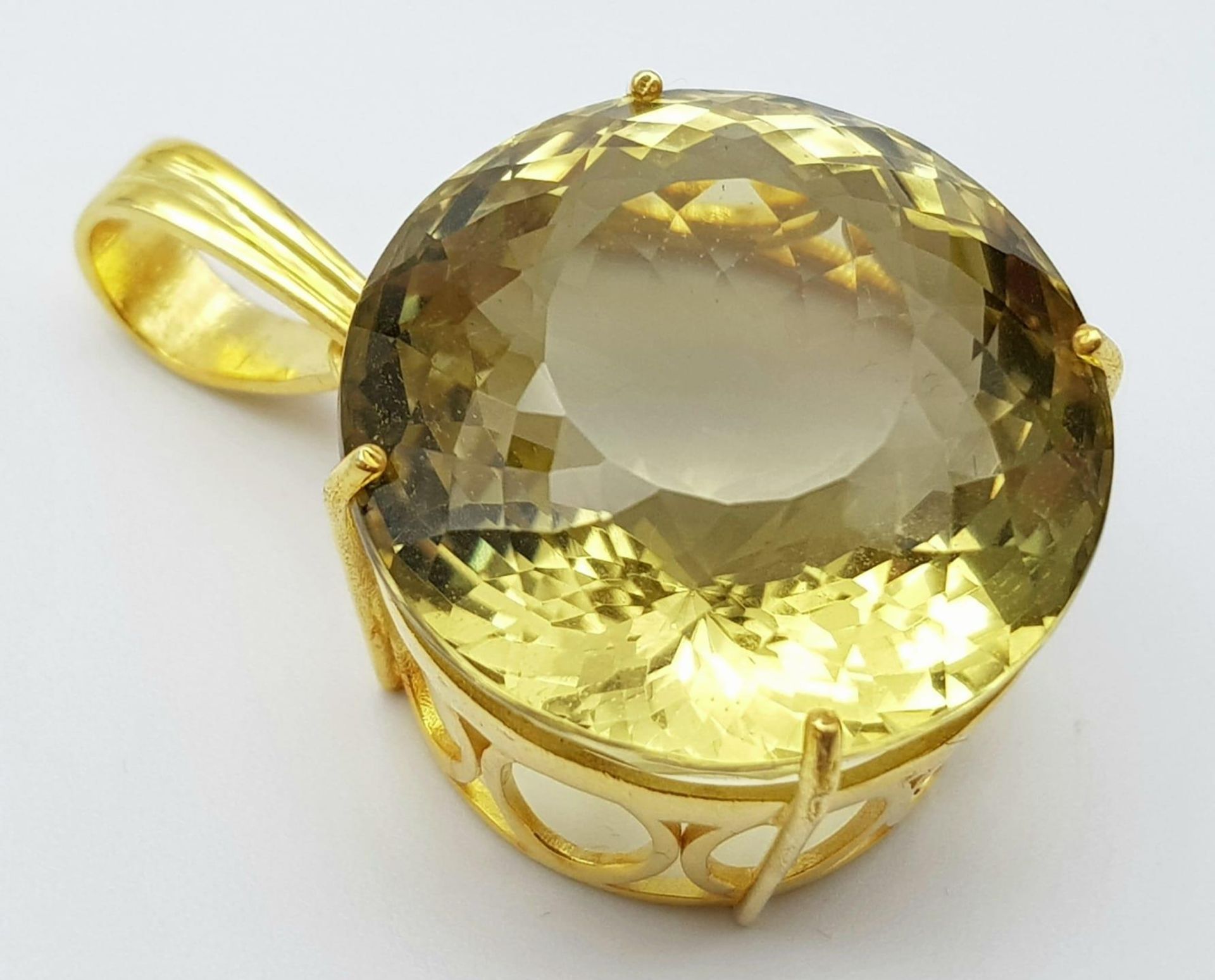A Round Lemon Quartz Pendant set in Gold Plated 925 Silver. Weight - 20g. Lemon Quartz - 66.65ct.