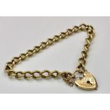A 9k yellow gold traditional charm bracelet with heart padlock. 18cm. 19g