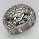 A Chanel, Designer 18K White Gold Diamond Encrusted Ring. This head-turning piece has