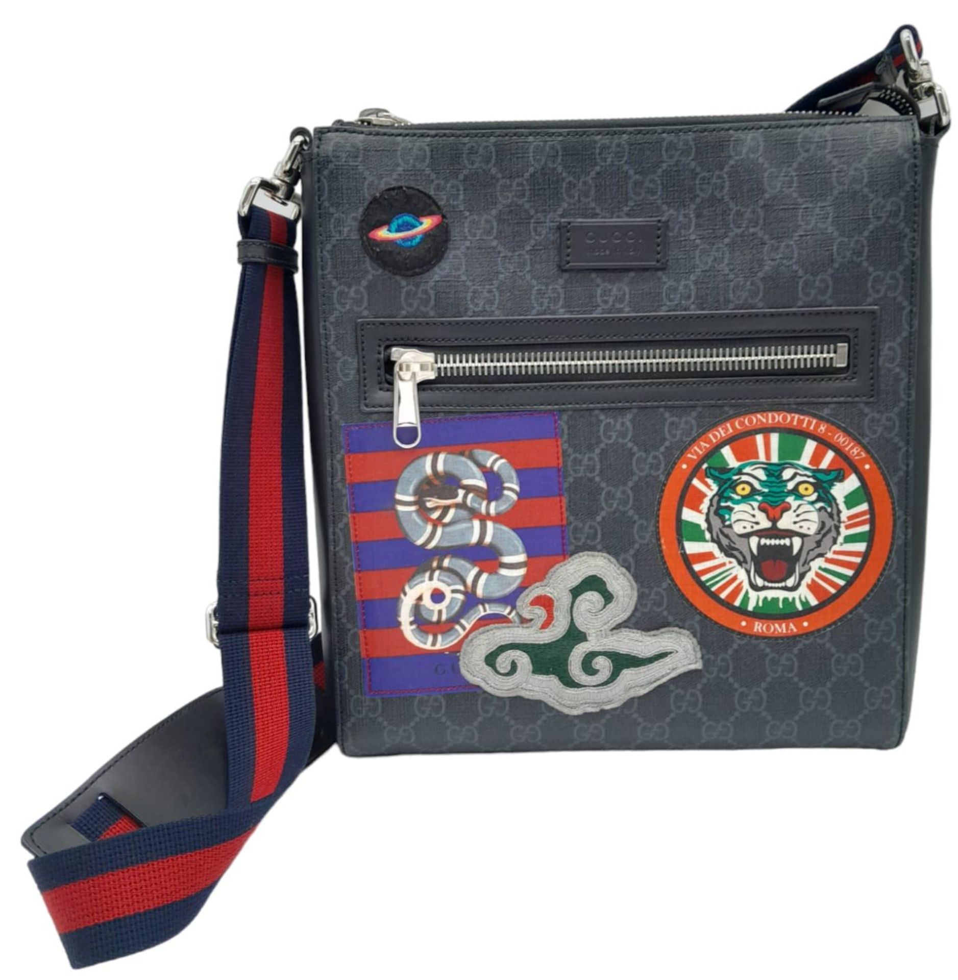 A Gucci Monogram Night Courier Messenger Bag. Leather exterior with patch details, silver-toned