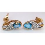 A PAIR OF 9K GOLD DIAMOND AND TOPAZ EARRINGS . 1gm