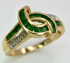 A 14K GOLD DIAMOND AND EMERALD RING . 3.3gms size O