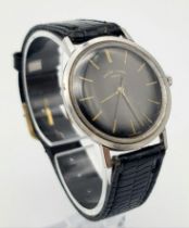 A Vintage Favre-Leuba Mechanical Gents Watch. Black leather strap. Thin stainless steel case - 33mm.