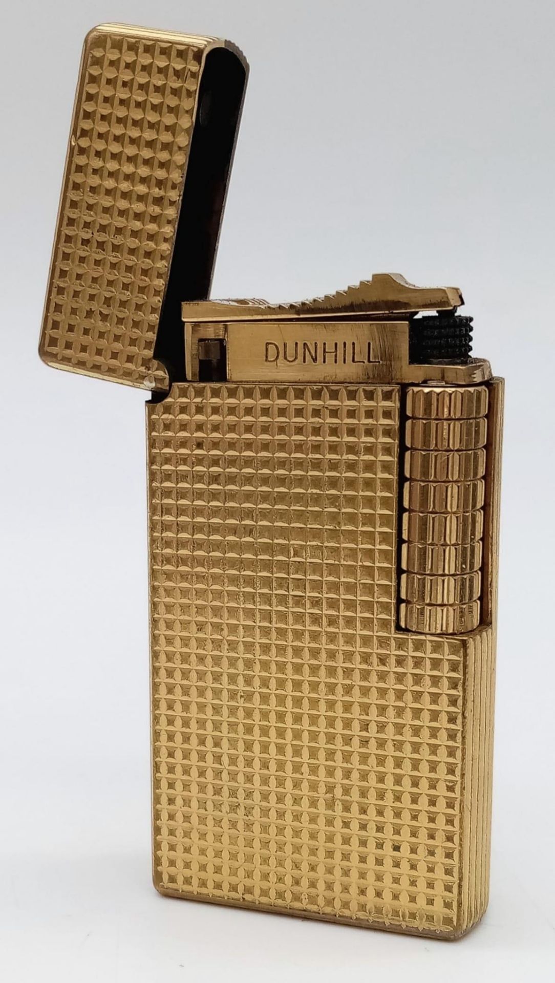 A Vintage Dunhill Gold Plated 70 Lighter. Textured exterior - 6cm x 3cm. In need of flint and gas.