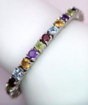 A Multi-gemstone Tennis Bracelet set in 925 Silver. Amethyst Citrine, Topaz and Peridot. 18cm