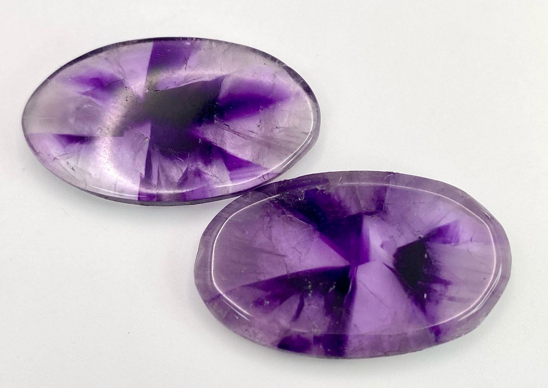 A rarely seen and very desirable pair of large AMETHYST cabochons, exhibiting radiating banded - Image 2 of 3
