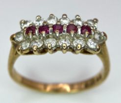 A Vintage 9K Yellow Gold Ruby and Diamond Ring. Five rubies with a twelve diamond surround. Size