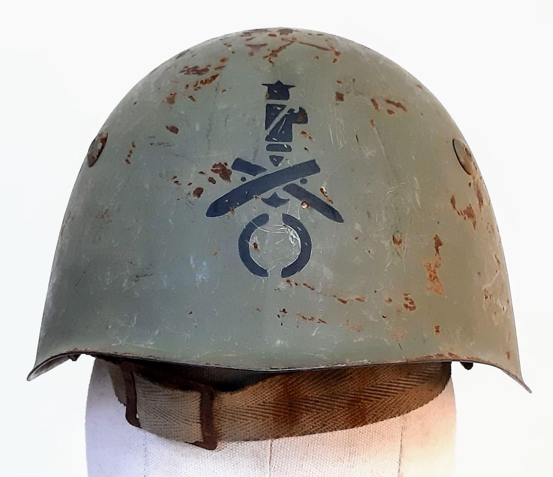 A WW2 Italian M33 Helmet with insignia of the Coastal Artillery.