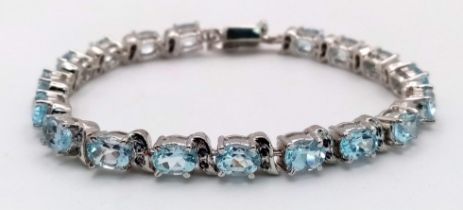 An Ice Blue Topaz Gemstone Tennis Bracelet set in 925 Silver. Weight - 25.30g. 18cm length. Ref: