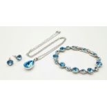 A matching set of white metal faceted blue stone jewellery include a pair of stud earrings, a link