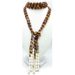 A very interesting necklace consisting of three very long (125 cm) strands of multicoloured beads