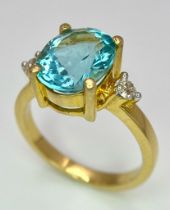 An 18K Yellow Gold, Aquamarine and Diamond Ring. 4ct central aquamarine with diamond accents. Size M