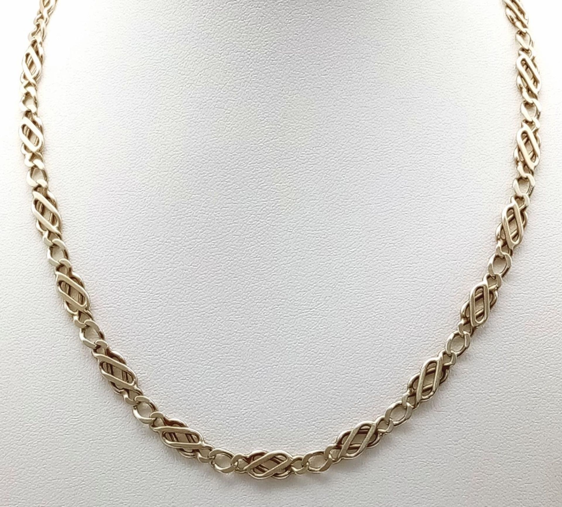 A 9k yellow gold fancy link chain. 17" length. 16.8g