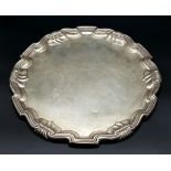 An Antique Sterling Silver Salver with a Decorative scrolled edge. 31cm diameter. 606g weight.