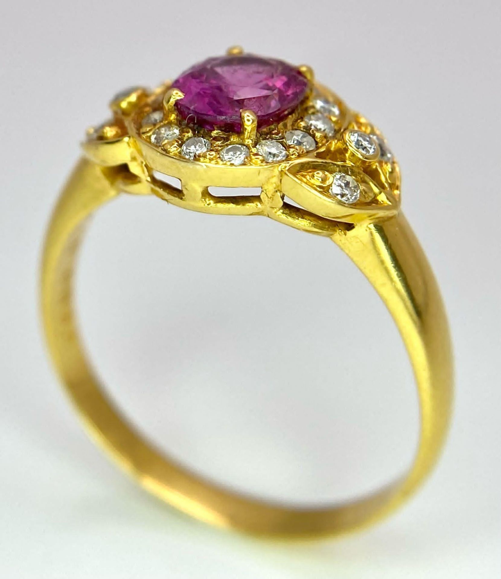 An 18K Yellow Gold Pink Sapphire and Diamond Ring. Central oval sapphire with diamond halo and - Image 5 of 12