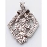 A 14K WHITE GOLD DIAMOND SET PENDANT, IN THE SHAPE OF BOW AND CLOVER. 0.30CT 3.4G , 27mm x 17mm ref: