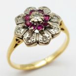 AN 18K GOLD RING WITH DIAMONDS AND RUBY SET IN PLATINUM IN FLORAL FORM . A VERY PRETTY RING . 4.