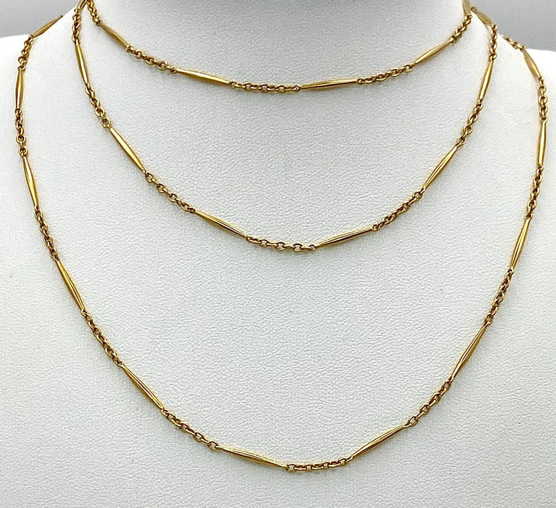 An unusual, 9 K yellow gold and very long (100 cm) chain necklace, that can be worn either as one